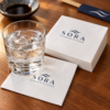 Illustrative custom restaurant branding on disposable paper napkins